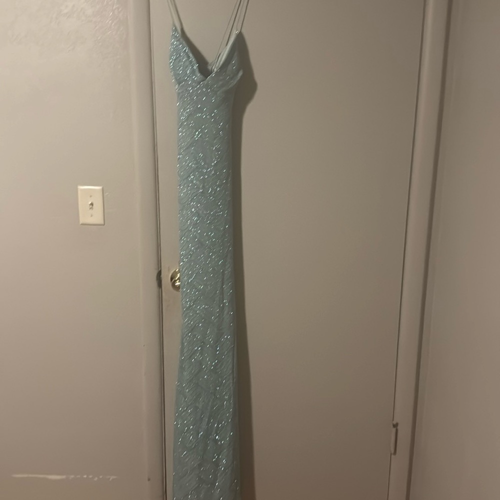 Pretty light blue prom dress worn once for junior prom has a small stain